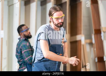 Carpenter working on the woodworking desk and furniture handmade with wood Stock Photo