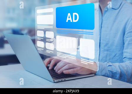 Programmatic in-feed advertisement on computer screen. Person viewing website with inbound ads to optimize click through rate and conversion. Digital Stock Photo