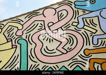 Strange figure painted by Keith Haring in Pisa. Detail from a mural named Tuttomondo created outdoor in 1989. Stock Photo