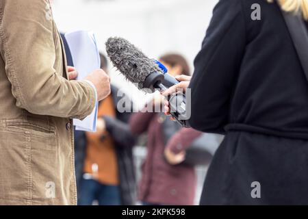 Whistleblower holding document and giving statement at media event or press conference Stock Photo