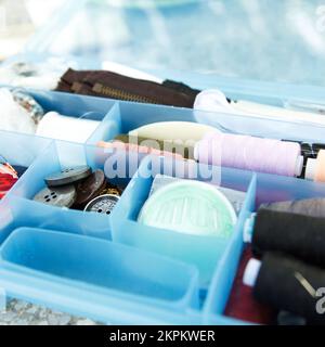 Comfortable box sewing kit with threads, needles and buttons to repair clothes at home Stock Photo