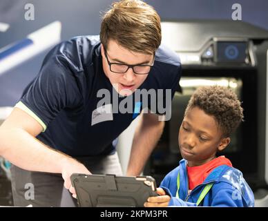 Brandon Stroick, a volunteer from the Medtronic Foundation helps a student from STARBASE Minnesota map out their Ozobots route in St. Paul, Nov. 1, 2022. The Minnesota Vikings and Medtronic volunteered their time to learn science, technology, engineering, and mathematics (STEM) from STARBASE Minnesota students. STARBASE Minnesota is a Department of Defense educational program that immerses students in real-world STEM throughout the school year and summer. Air National Guard,Minnesota Air National Guard,Minnesota National Guard,Minnesota Vikings,STARBASE Minnesota, Stock Photo