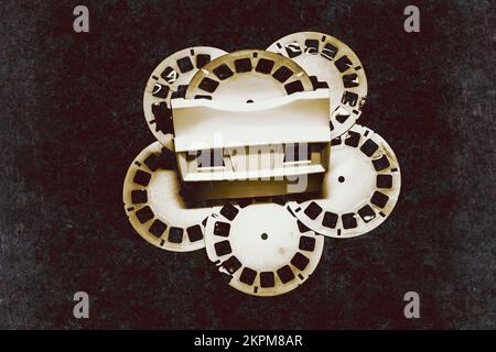 Nostalgic art on a old film reel toy dusted by a haze of past texture.  Vintage film toy Stock Photo - Alamy