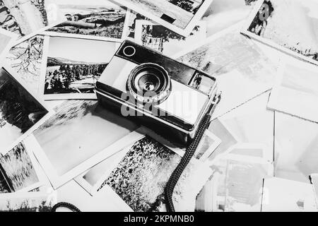 Black and white photography on a classic film camera placed on flashbacks from past travels. Gallery in monochrome Stock Photo