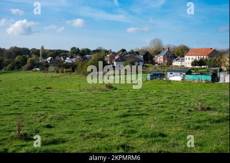 Asse, Flemish Brabant Region, Belgium - 10 20 2022 - Scenic view over green hills and meadows ith residential houses in the background Stock Photo