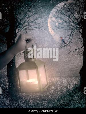 A winters scene made up of composite photographs, featuring a hand holding a lamp in a snow covered forest, under a full moon Stock Photo