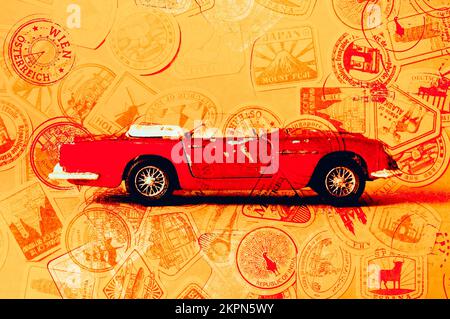 Travel art on an iconic toy Aston Martin DB5 stamped by insigna of holiday fun. Touring car Stock Photo