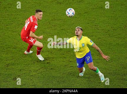 Brazil's Bruno Guimaraes (right) and Switzerland's Michel Aebischer in action during the FIFA World Cup Group G match at Stadium 974 in Doha, Qatar. Picture date: Monday November 28, 2022. Stock Photo