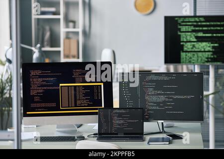 Computers and laptop on office desk, programming and testing concept Stock Photo