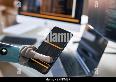 Closeup image of software developer holding smartphone with prosthetic arm Stock Photo