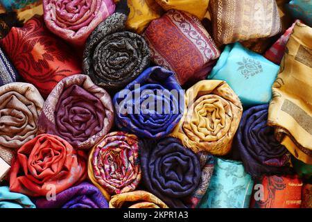 colorful fabrics, bedspreads and kerchiefs with different oriental patterns.  Stock Photo