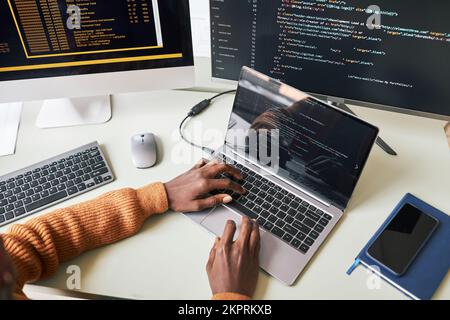 Hands of young man testing programming code for new application on laptop Stock Photo