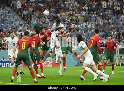 Lusail, Qatar. 28th Nov, 2022. Jose Maria Gimenez (5th L) of Uruguay heads the ball during the Group H match between Portugal and Uruguay at the 2022 FIFA World Cup at Lusail Stadium in Lusail, Qatar, Nov. 28, 2022. Credit: Li Ga/Xinhua/Alamy Live News Stock Photo