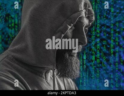 man with hood on a dark background depression or hacker Stock Photo