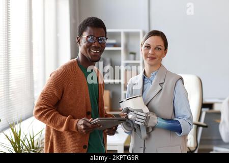 Team of young scientist working on new VR application for people with prosthetic arms Stock Photo