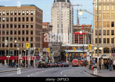 Ottawa, Canada - November 5, 2022: Busy Rideau street in downtown district. Cityscape with intersection, traffic lights, and walking people. Stock Photo