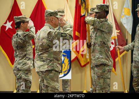 U.S. Army Col. Carrie Perez, commander of the 36th Sustainment Brigade and Command Sgt. Maj. Ernesto Castillo, senior enlisted advisor to Perez, render a salute prior to casing their brigade’s flag during a transfer of authority ceremony, Nov. 3, 2022, at Camp Arifjan, Kuwait. The transfer of authority ceremony signifies the end of the responsibilities of Task Force Phoenix followed by the assumption of responsibility by Task Force Hellfighter. Stock Photo