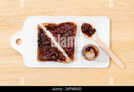 Flat lay of Toast sandwich with raspberry organic jam on wooden table Stock Photo