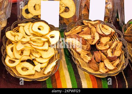 Dry fruits in rattan baskets sold outside on market stall Stock Photo