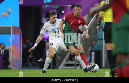 Lusail, Qatar. 28th Nov, 2022. Uruguay's Sebastian Coates and Portuguese Cristiano Ronaldo fight for the ball during a soccer game between Portugal and Uruguay, in Group H of the FIFA 2022 World Cup in Lusail Stadium, in Lusail, State of Qatar on Monday 28 November 2022. BELGA PHOTO VIRGINIE LEFOUR Credit: Belga News Agency/Alamy Live News Stock Photo