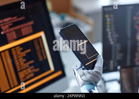 Closeup image of developer with bionic hand testing new mobile application Stock Photo
