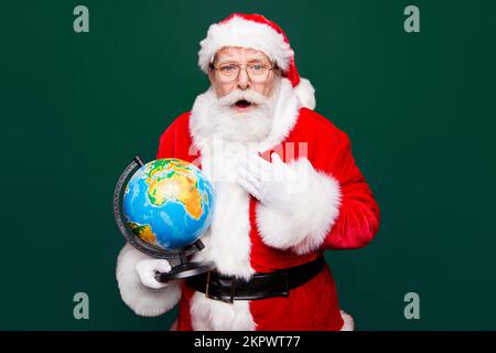 Holly jolly winter coming! Grandfather aged Santa white beard in costume gloves headwear look with excited reaction emotion face open mouth staring Stock Photo