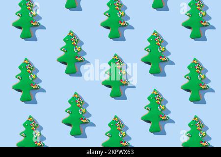Christmas cookies seamless pattern of Christmas tree shape cookie on blue background. Winter holidays dessert ornament Stock Photo