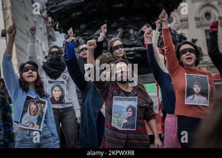 London, UK. 26th November, 2022. British-Iranian women and supporters protest in Piccadilly Circus continuing their demand for regime change in Tehran, Iran. Protesters are calling for justice for the hundreds of protesters killed since the death of 22-year old Mahsa Amini. In the days since her death on September 16th, demonstrations have erupted globally and hundreds of protesters have been killed in Iran, according to human rights groups. Credit: Guy Corbishley/Alamy Live News Stock Photo