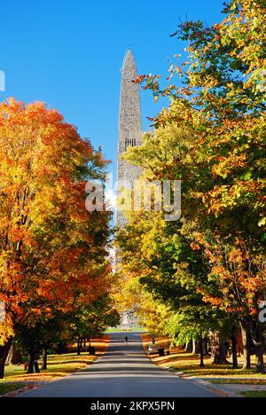 Fall colors and foliage surround the obelisk of the Bennington Battle Monument on a sunny autumn day in Vermont, New England Stock Photo