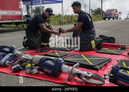 Firefighters prepare equipment used for vehicle rescue operations during joint training on Marine Corps Base (MCB) Camp Blaz, Guam, Nov. 4, 2022. The training included firefighters from  MCB Camp Blaz, Naval Base Guam, Andersen Air Force Base and the Guam Fire Department. The training strengthened the island-wide team's ability to respond to future fire and rescue emergencies. The purpose of this training was to bring firefighters from all the services  and the Guam Fire Department to train through different modules that included: ground ladder tactics, victim removal, aerial ladder confidence Stock Photo