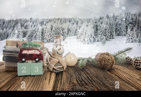 red toy car carrying christmas tree in a snow forest. Copy space greeting card with festive decoration. new year holiday concept. Stock Photo