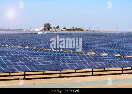 Rows of solar panels under blue sky in autumn Stock Photo