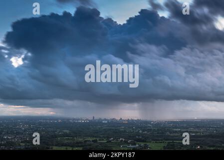 A rain cloud over Manchester city centre viewed from Hartshead Pike, Mossley, in September 2017. Stock Photo