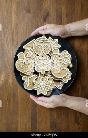 Rustic Note Paper Background Gingerbread man in female hands on dark rustic background with ...