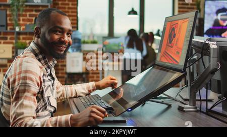 Creative office worker sitting at computer and creating digital art in agency studio, using multiple monitors and cad software. Professional graphic designer working on develoment project. Stock Photo