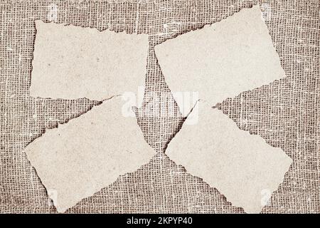 Set of craft paper with torn edges on natural background of sackcloth, copy space Stock Photo