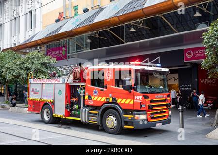 Fire engine truck in Melbourne city centre, Fire Rescue Victoria, Australia as fire staff attend to a call, female woman driver Stock Photo