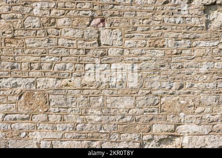 Ancient stone wall pattern or texture. Detail of an old UK church exterior Stock Photo