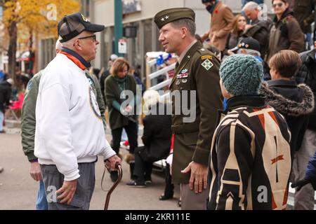 Maj. Gen. David Hodne, commanding general of the 4th Infantry Division and Fort Carson, speaks to a local veteran during the Veterans' Day parade in downtown Colorado Springs, Colorado, Nov. 5, 2022. Hodne participated in the Colorado Springs Veterans' Day parade as the reviewing officer in the day's events. Stock Photo