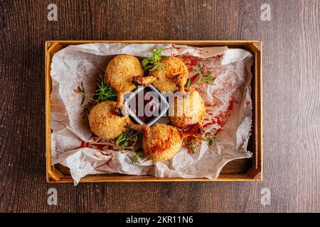 deep-fried chicken legs with sauce. Stock Photo