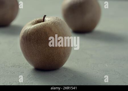 Yellow orange apples on a grey table Stock Photo