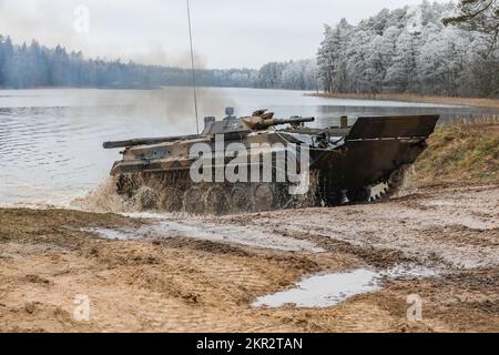 Polish soldiers assigned to 20th Mechanized Brigade operating a BMP-1 conduct amphibious assault training during the Bull Run training exercise at Bemowo Piskie, Poland, Nov. 23, 2022. The 20th Mechanized Brigade is proudly working alongside the 1st Infantry Division, NATO allies and regional security partners to provide combat-credible forces to V Corps, under America's forward deployed corps in Europe. (U.S. Army National Guard photo by Staff Sgt. Matthew A. Foster) Stock Photo