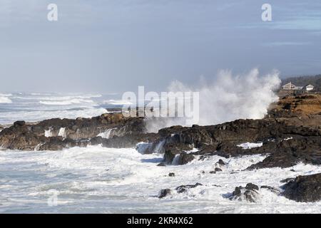 Huge waves crashing against the rocky shoreline during a king tide in Yachats, Oregon. Stock Photo