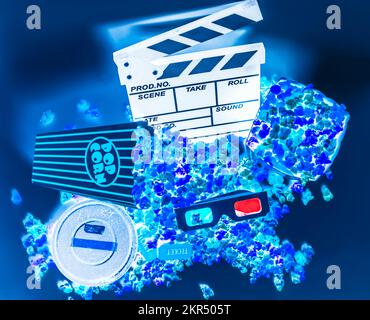 Creative movie artwork on a mix of filmmaking equipment and cinema icons. Blue screen entertainment Stock Photo