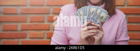 Close up of woman holding dollar bills. Stock Photo