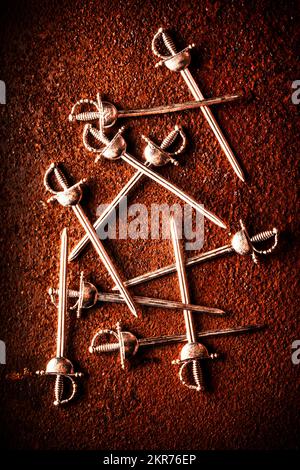 Medieval still life scene on a collective of rapier swords crossing paths of a knights tournament Stock Photo