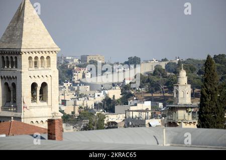 A view of the the Lutheran Church of the Redeemer and the barrier wall in the background. Jerusalem, Israel. Stock Photo