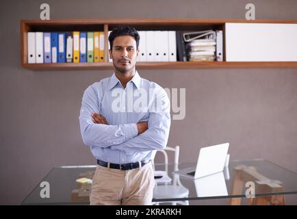 Hes ready for whatever the business world throws at him. a handsome young businessman in his office. Stock Photo