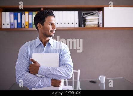 Hes ready for whatever the business world throws at him. a handsome young businessman in his office. Stock Photo