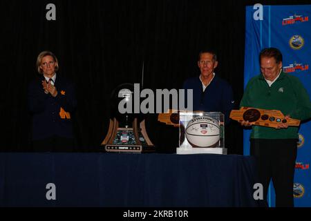 221110-N-MU675-2058 SAN DIEGO (Nov. 10, 2022) Capt. Amy Bauernschmidt, left, commanding officer of the Nimitz-class aircraft carrier USS Abraham Lincoln (CVN 72), presents plaques to Mark Few, middle, from Creswell. Ore., head coach of Gonzaga University men’s basketball and Tom Izzo, right, from Iron Mountain, Mich., head coach of Michigan State University men’s basketball at the 2022 ESPN Armed Forces Classic - Carrier Edition celebration dinner at the San Diego Air and Space Museum Nov. 10, 2022. The ESPN Armed Forces Classic is an annual series of college basketball games held near Veteran Stock Photo